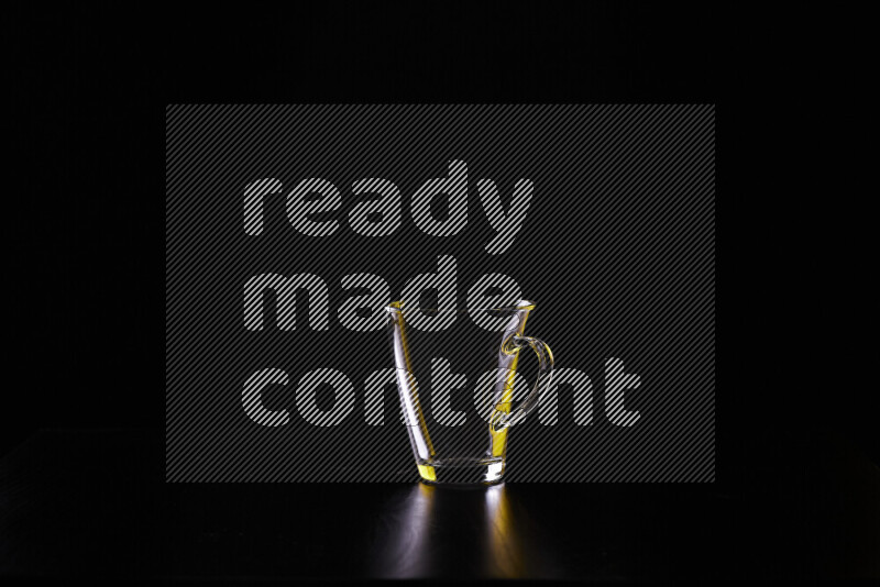 Glassware with rim light in yellow and white against black background