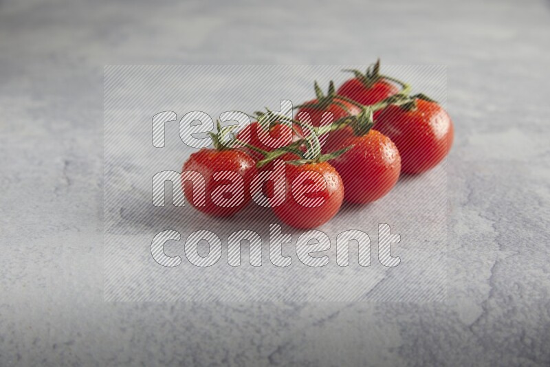 Red cherry tomato vein on a light grey textured background 45 degree