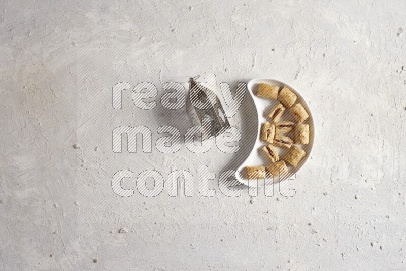 Oriental sweets in a pottery plate with lantern in a light setup