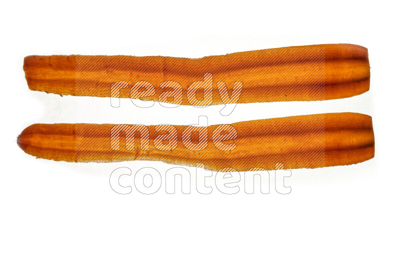 Carrots slices on illuminated white background