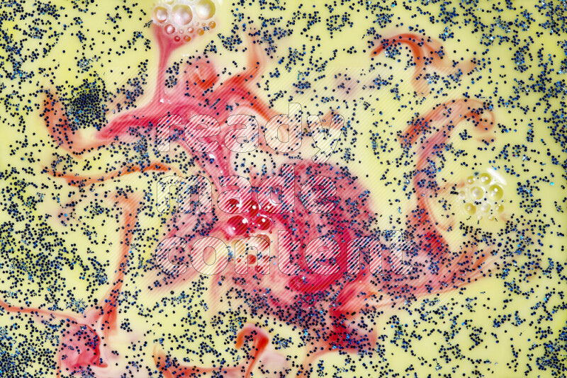 لقطة مقربة لبريق أزرق متلألئ منتشر على خلفية من اللون الأصفر والأحمر في حركات دائرية