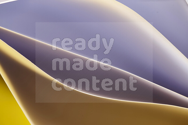 This image showcases an abstract paper art composition with paper curves in purple and gold gradients created by colored light