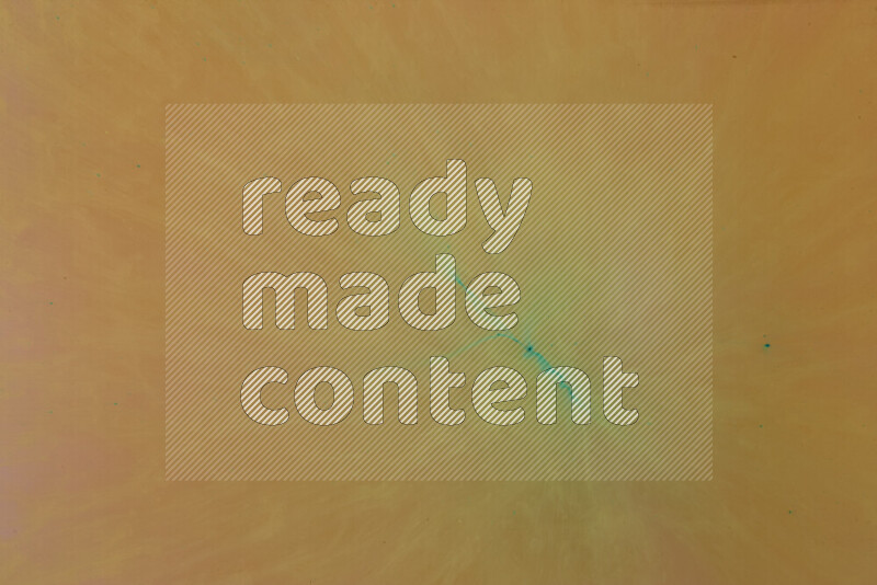 The image captures a dramatic splatter of green paint over a orange backdrop