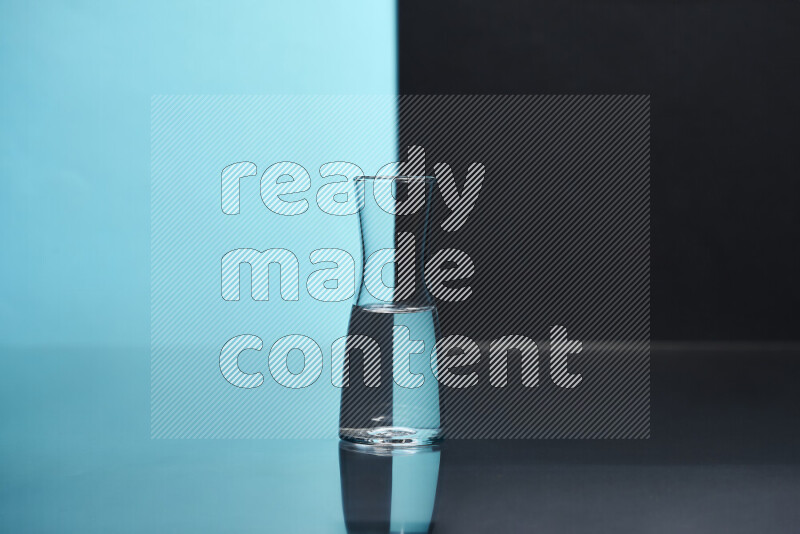 The image features a clear glassware filled with water, set against light blue and black background