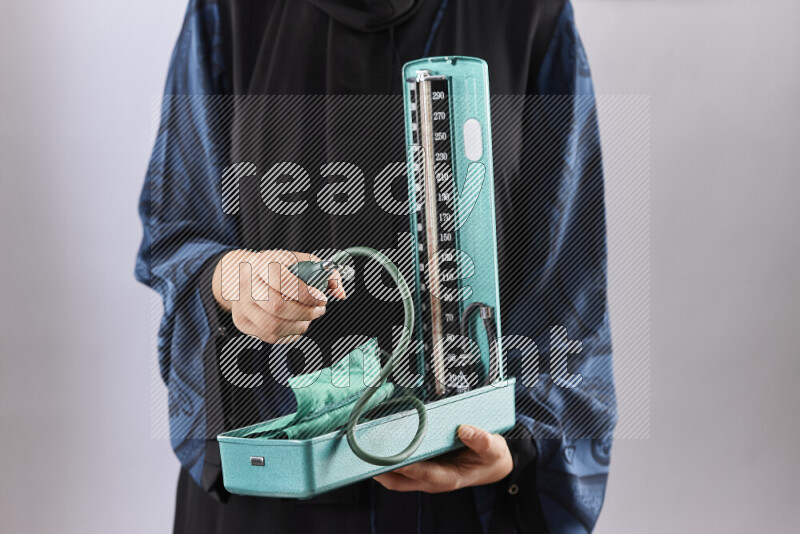 Female doctor wearing an abaya and medical attire in different positions