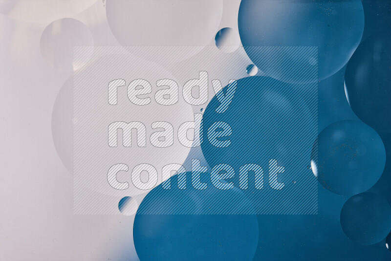 Close-ups of abstract oil bubbles on water surface in shades of white and blue