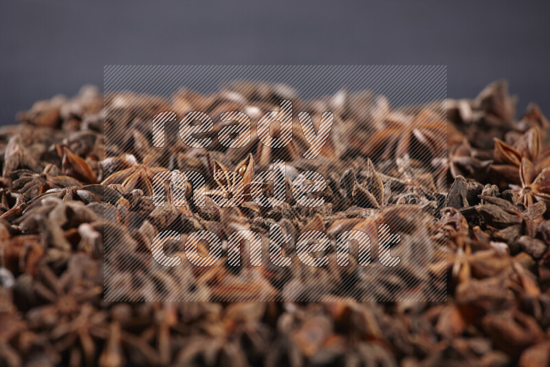 Star Anise fill the frame on black flooring