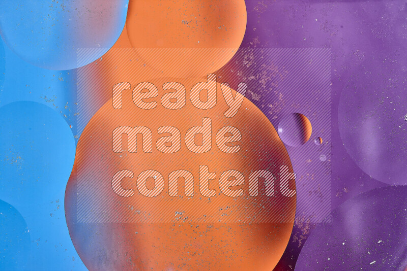 Close-ups of abstract oil bubbles on water surface in shades of blue, orange and purple