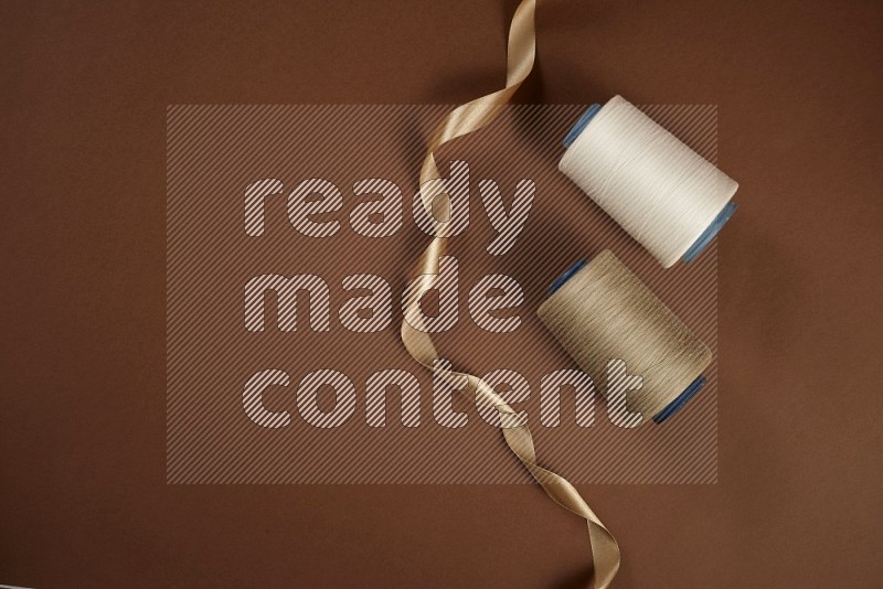 White sewing supplies on brown background