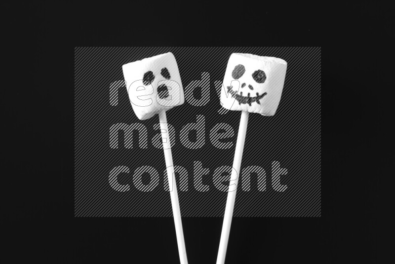 Halloween shapes on marshmallows on black background