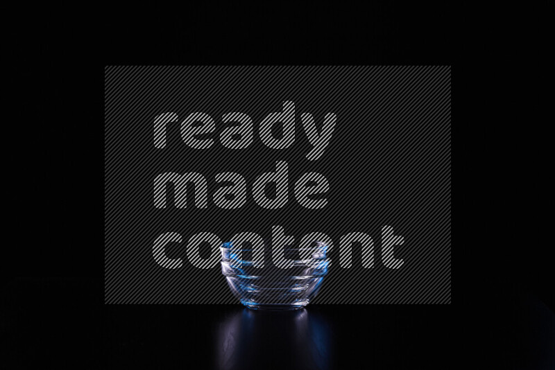 Glassware with rim light in blue and white against black background