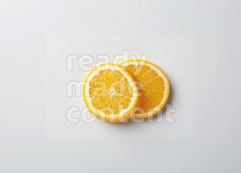 Two orange slices on white background