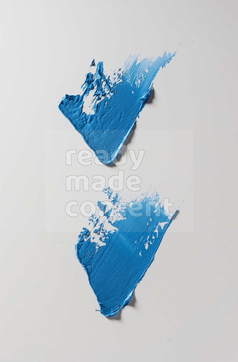 Blue painting knife strokes on white background