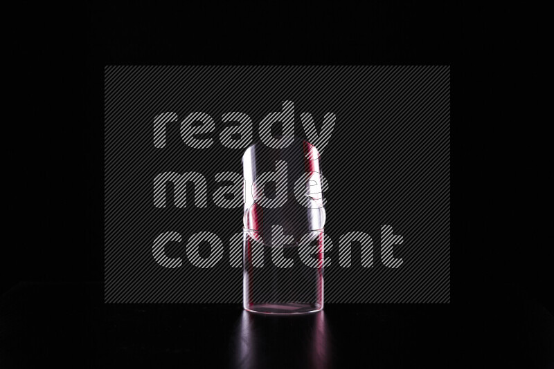 Glassware with rim light in red and white against black background