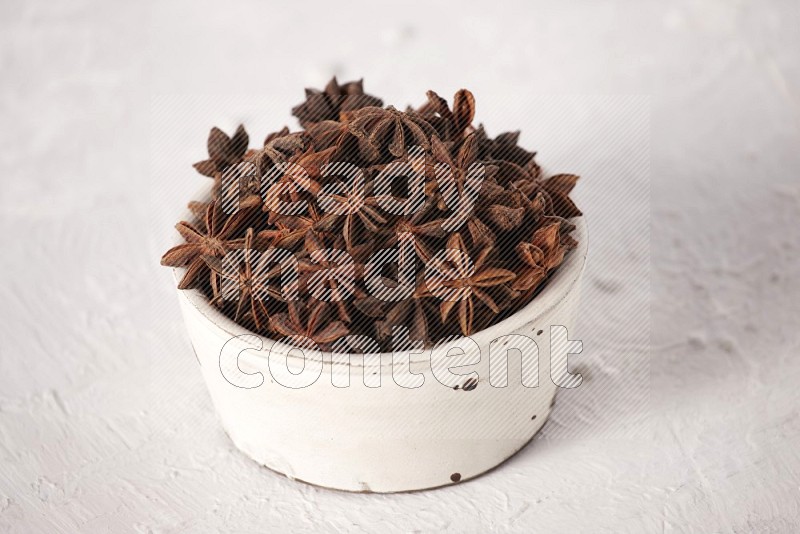 Star Anise in a white bowl on white background