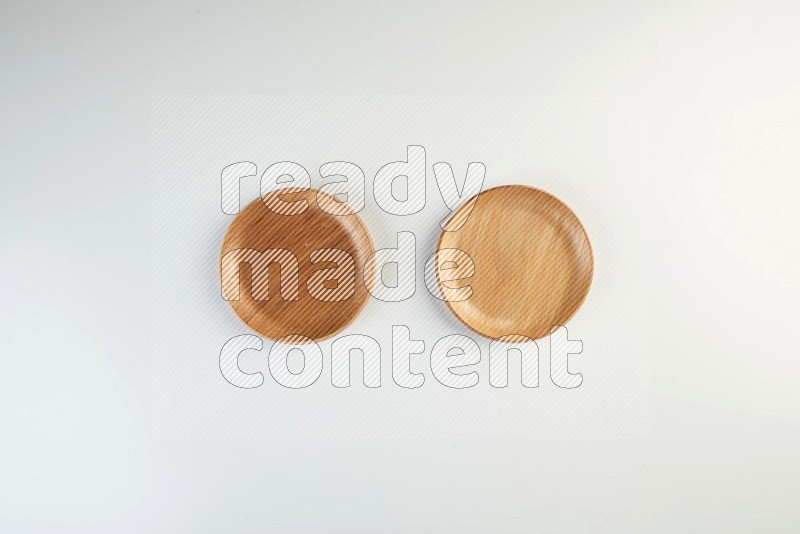 Wooden bowl and plate on white background