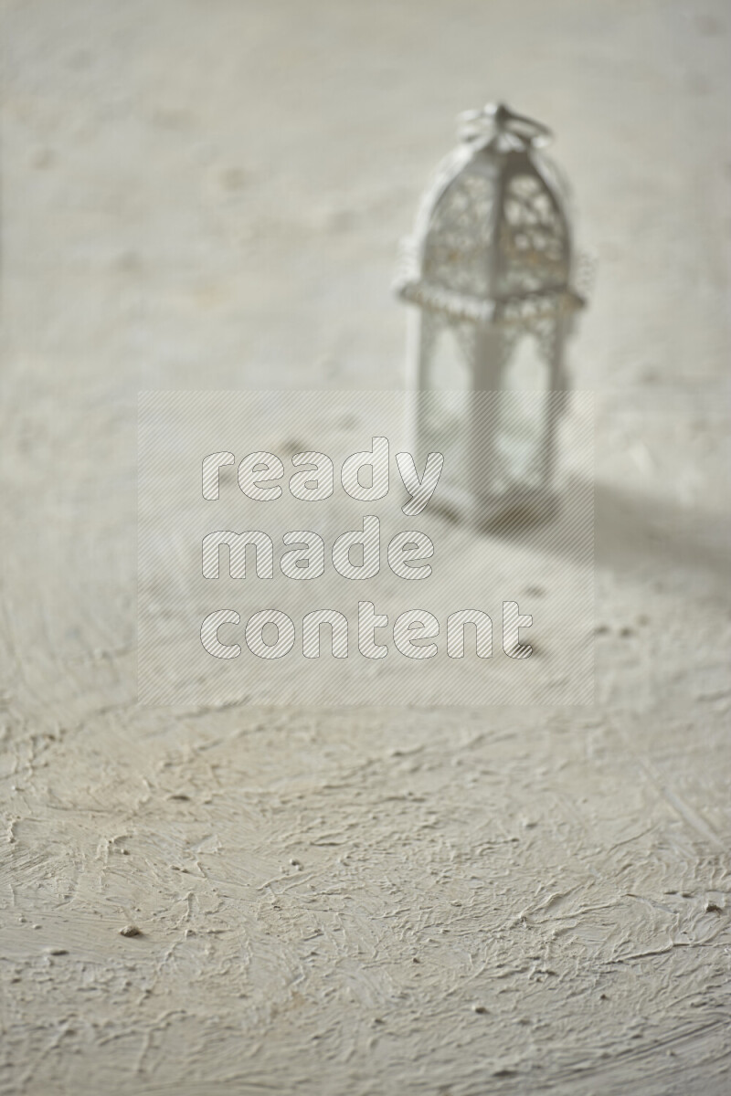 A lantern placed on a textured white background