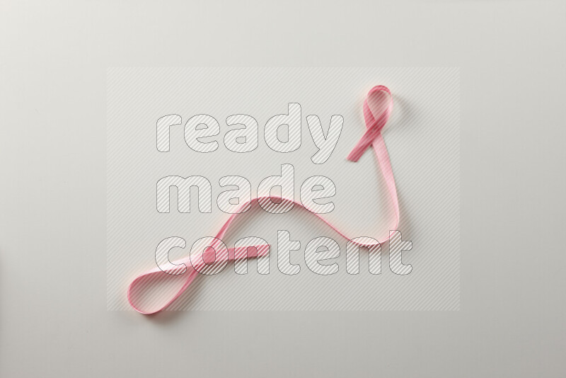 Pink ribbons on white background