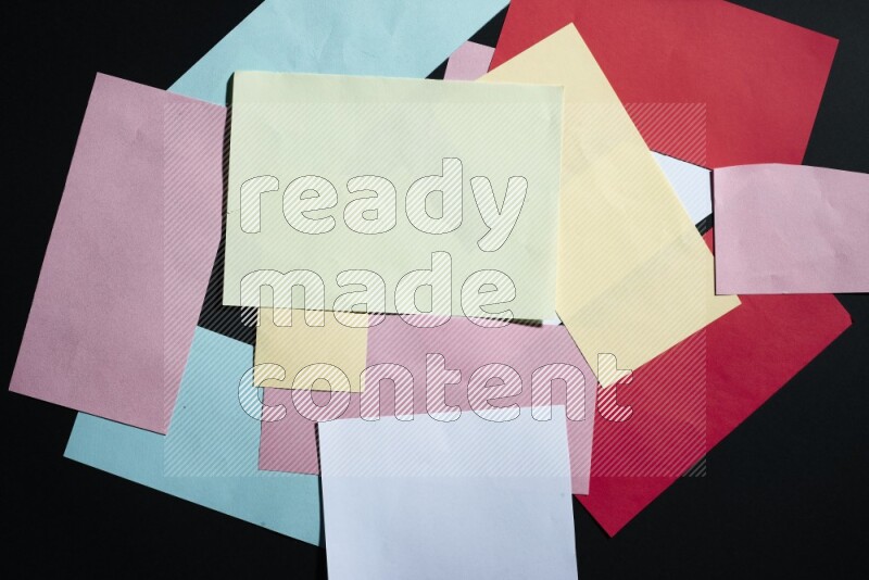Multicolored paper sheet on black background