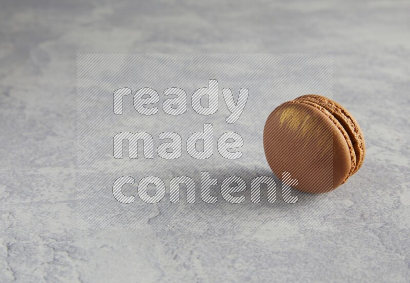 45º Shot of Brown Coffee macaron on white  marble background