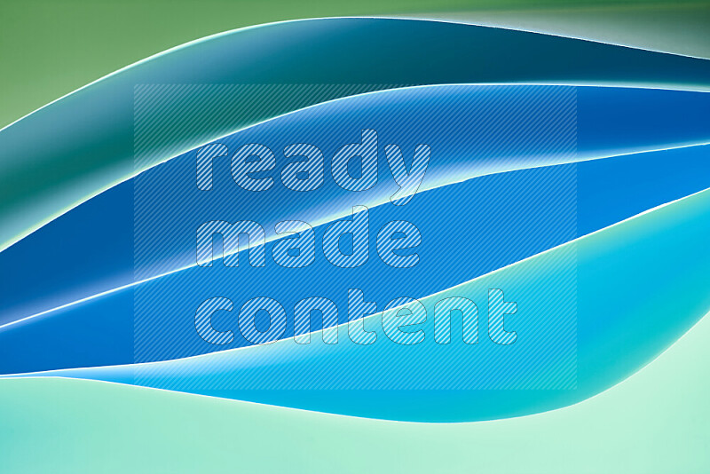 This image showcases an abstract paper art composition with paper curves in green and blue gradients created by colored light