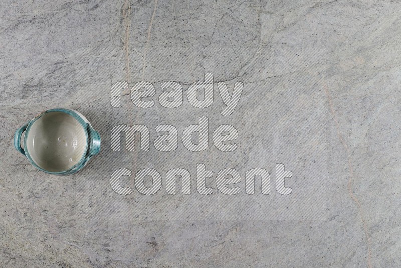 Top View Shot Of A Multicolored Pottery Bowl On Grey Marble Flooring