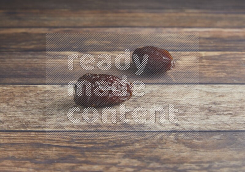 two madjoul dates on a wooden background