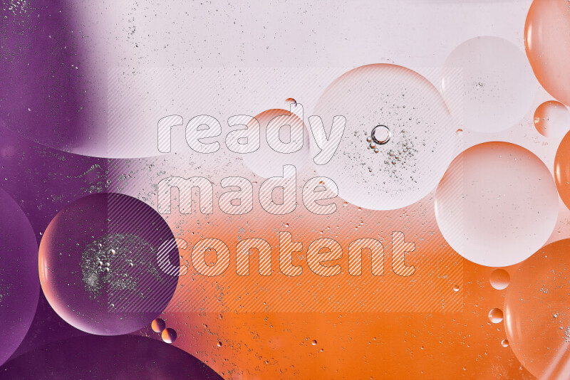 Close-ups of abstract oil bubbles on water surface in shades of white, orange and purple