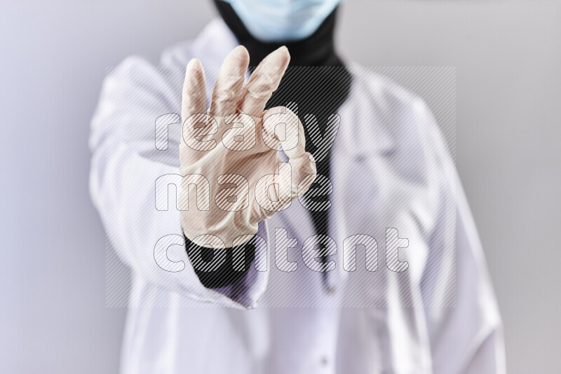 Female doctor wearing an abaya and medical attire in different positions
