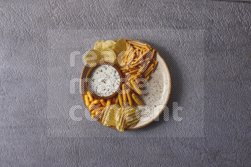 Assorted snacks in pottery bowls on grey background