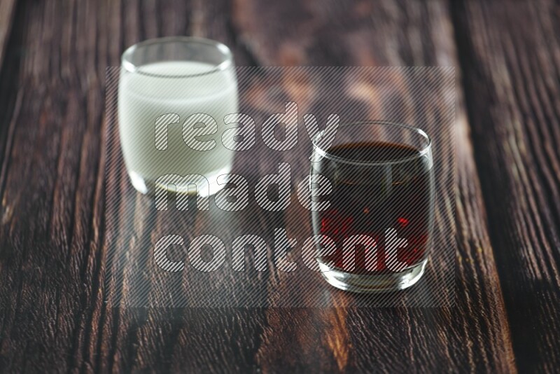 Cold drinks in a glass cup such as water, tamarind, qamar eldin, sobia, milk and hibiscus on wooden background
