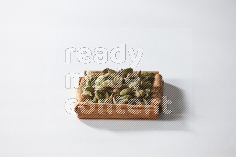 A single square of cinnamon sticks full of cardamom on white flooring