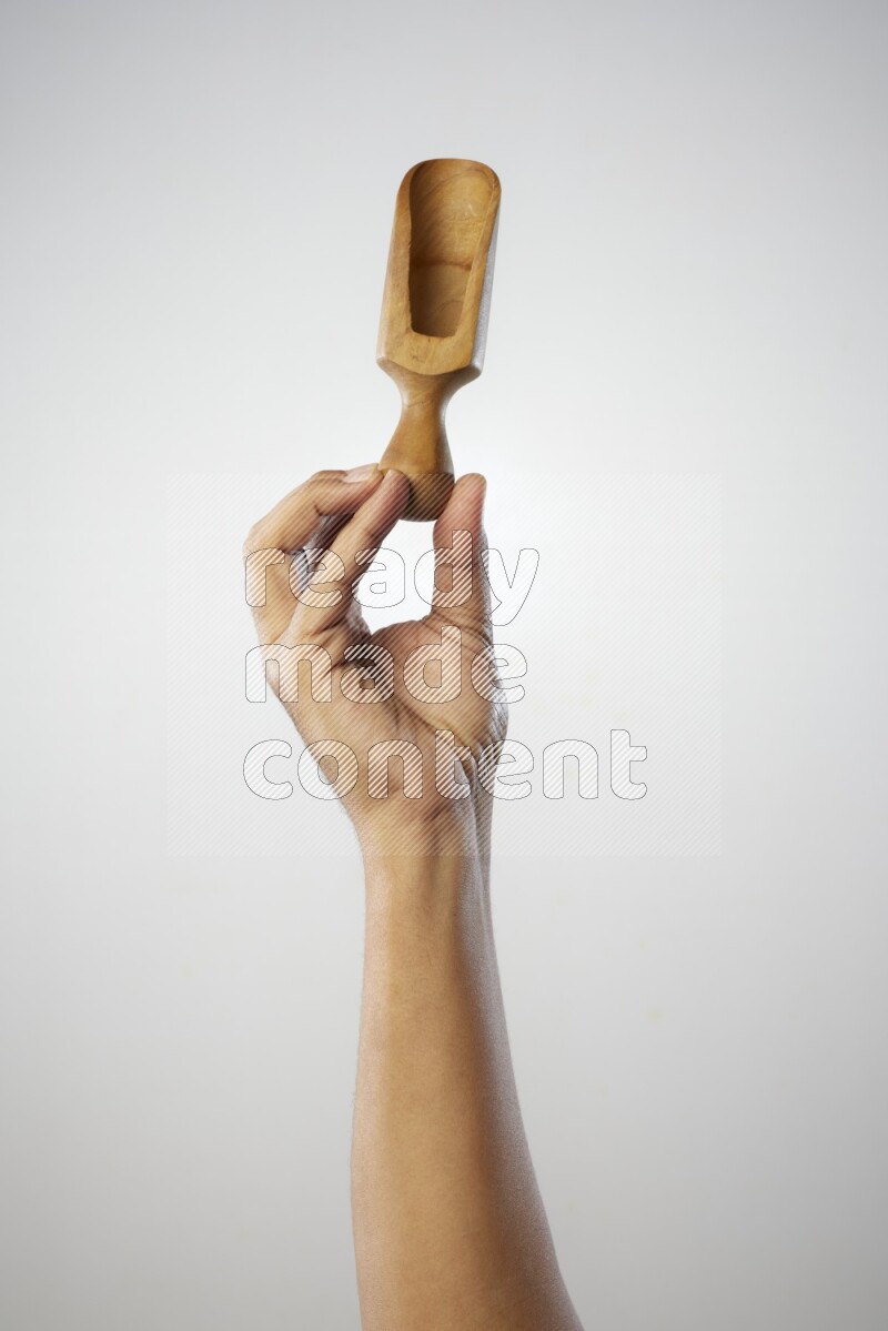 Male Hand Holding Wooden scoop