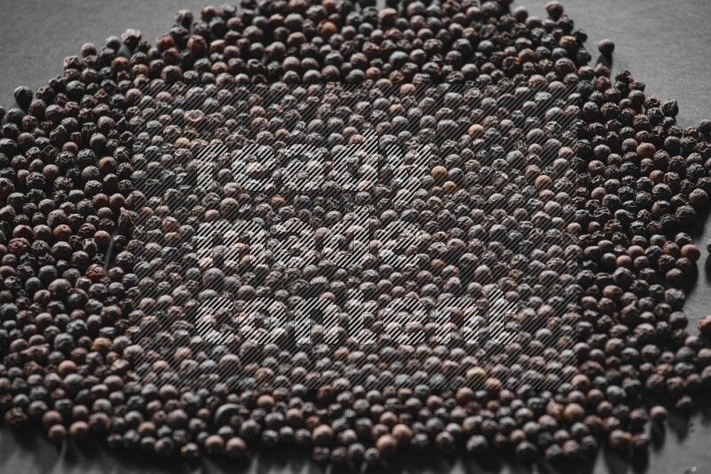 Black pepper on a black flooring