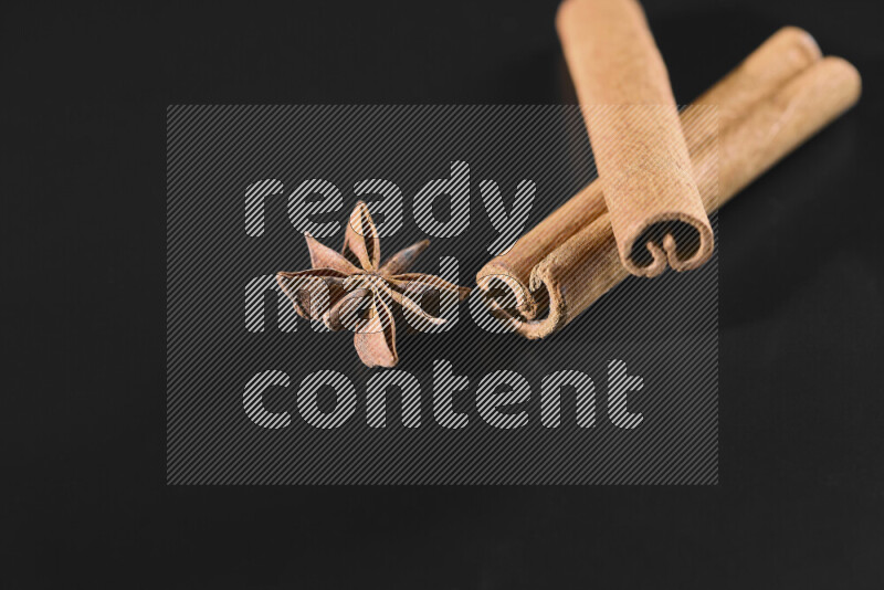 Cinnamon sticks and star anise on black background