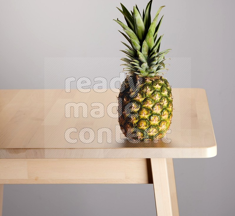 pineapple on the edge of wooden table