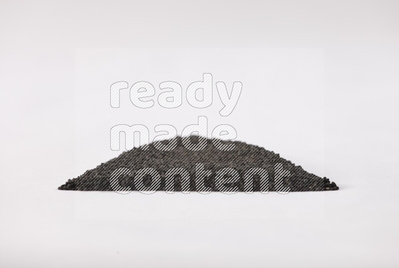 Black seeds in a triangle shape on a white flooring