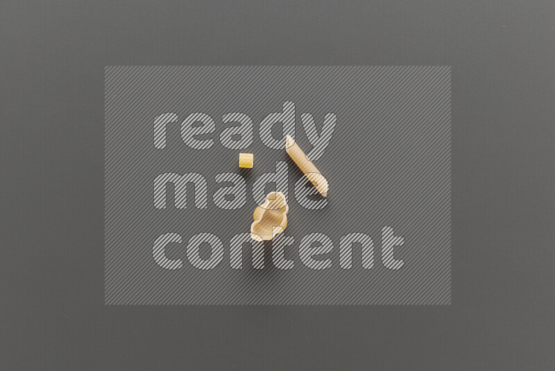 Different pasta types on grey background