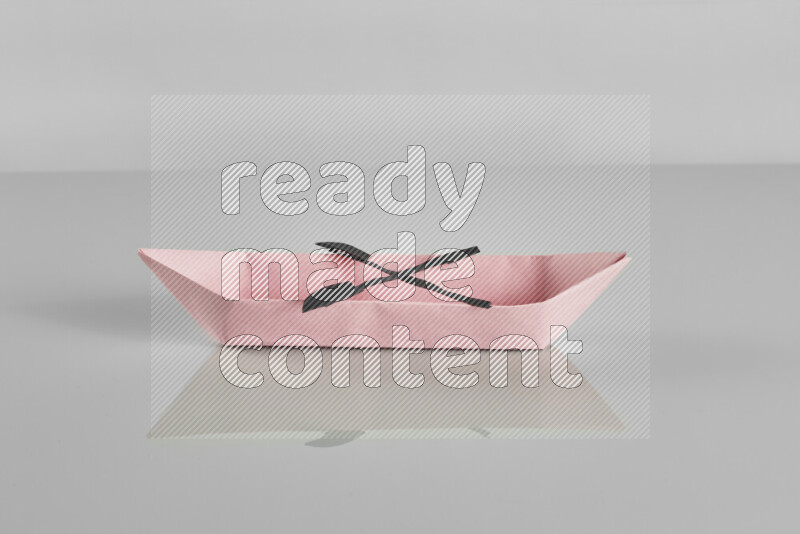 Origami boat on grey background