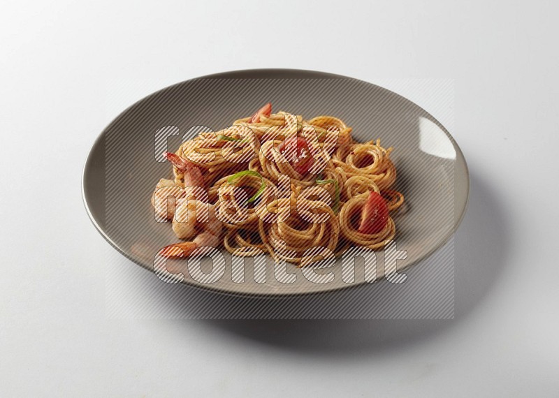 spaghetti pasta with red sauce on a grey plate on a white background