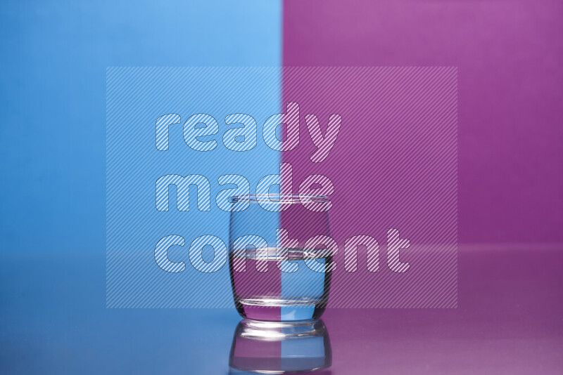 The image features a clear glassware filled with water, set against blue and purple background