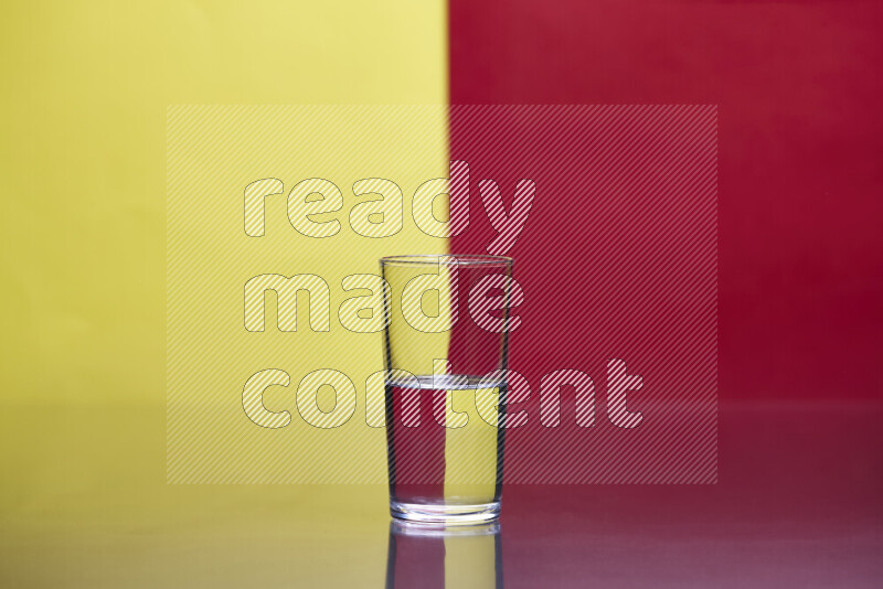 The image features a clear glassware filled with water, set against yellow and red background