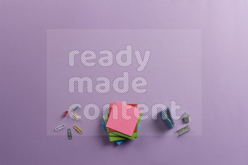 Multicolored sticky notes with school supplies on purple background