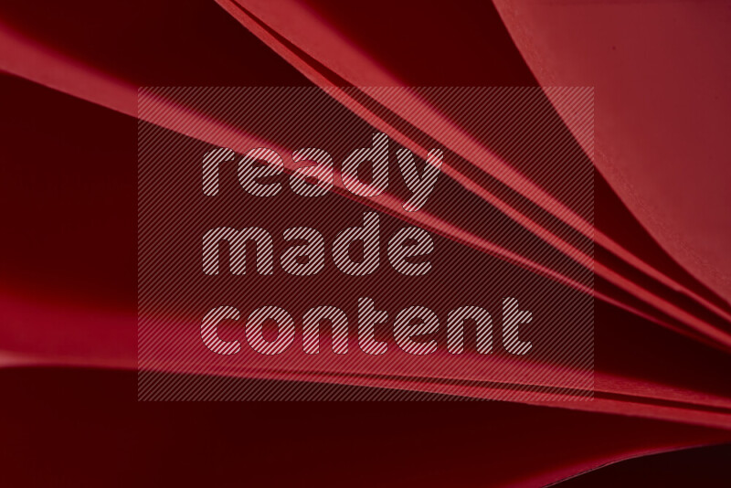 An abstract art showing red paper sheets arranged in an overlapping curves