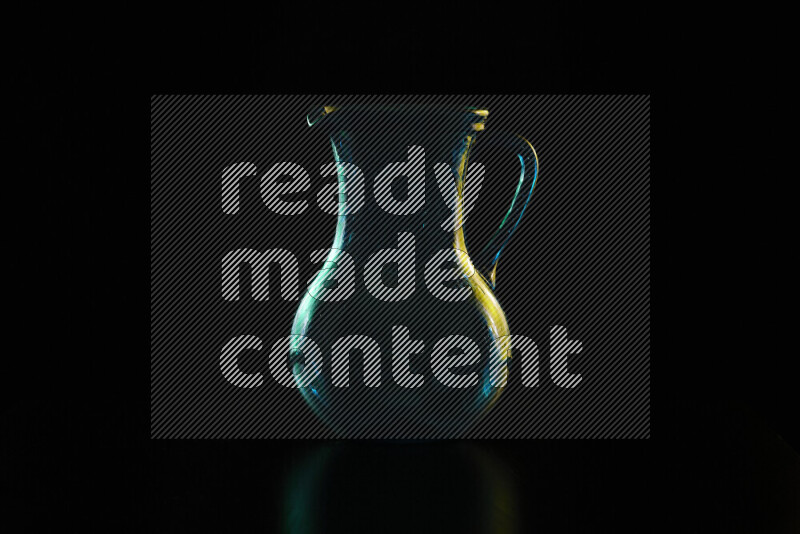 Glassware with rim light in green and yellow against black background