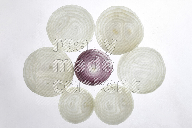 Onion slices on illuminated white background