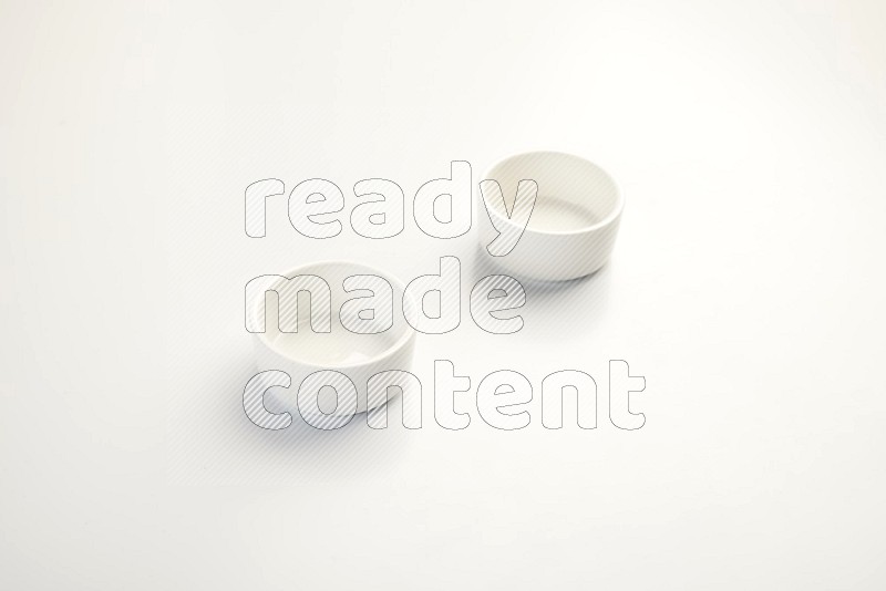 white ceramic round sauce dish on white countertop