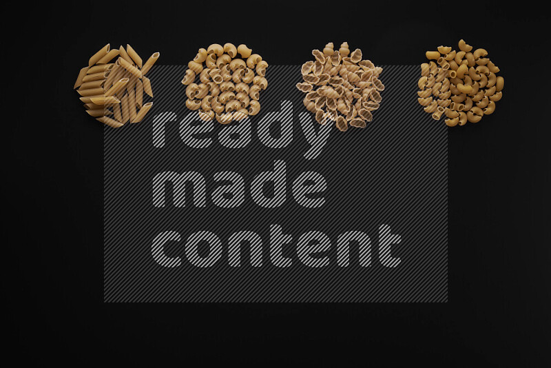 Different pasta types in 4 bunches on black background