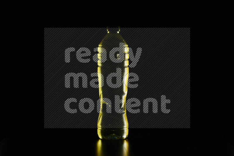 Water bottle with colored rim light against black background