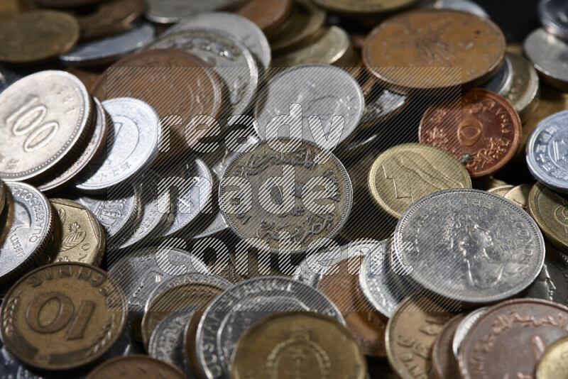 A close-ups of random old coins on black background